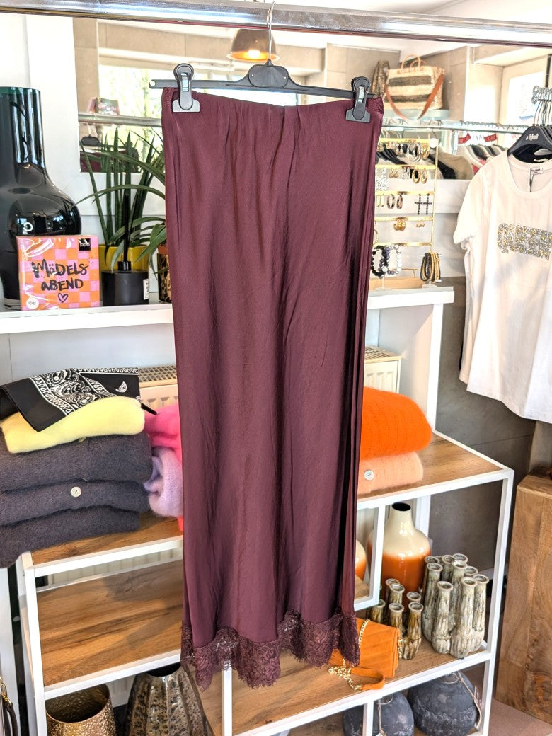 Verleihe deinem Outfit einen Hauch von Eleganz mit diesem langen Satin Rock aus Viskose in Burgund Rot mit brauner Spitze. Perfekt für das gewisse Etwas!