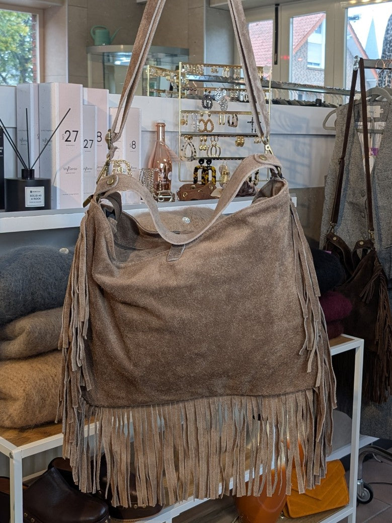 Die Wildledertasche in warmem Taupe überzeugt mit großzügigem Format, Schulterriemen, RV und stilvollen Fransen, die jedem Outfit eine trendige Note verleihen!