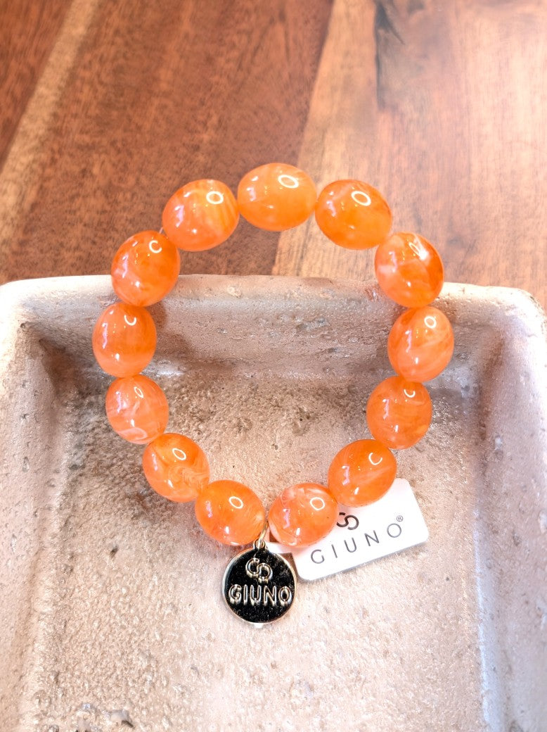 Elegantes elastisches Armband mit großen Acryl-Ovalen in Orange. Das hochwertige Design verbindet moderne Ästhetik mit komfortablem Tragekomfort!