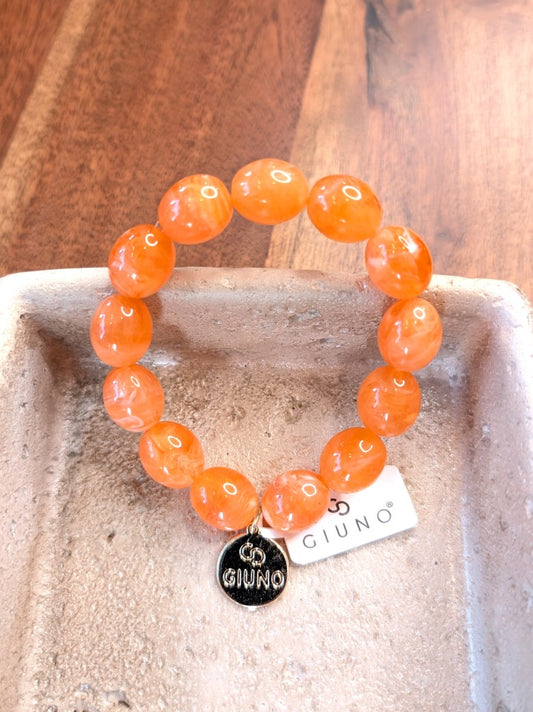 Elegantes elastisches Armband mit großen Acryl-Ovalen in Orange. Das hochwertige Design verbindet moderne Ästhetik mit komfortablem Tragekomfort!