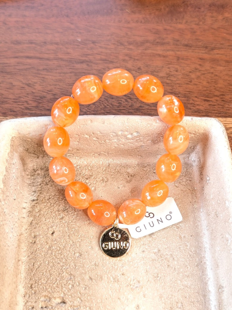 Elegantes elastisches Armband mit großen Acryl-Ovalen in Orange. Das hochwertige Design verbindet moderne Ästhetik mit komfortablem Tragekomfort!