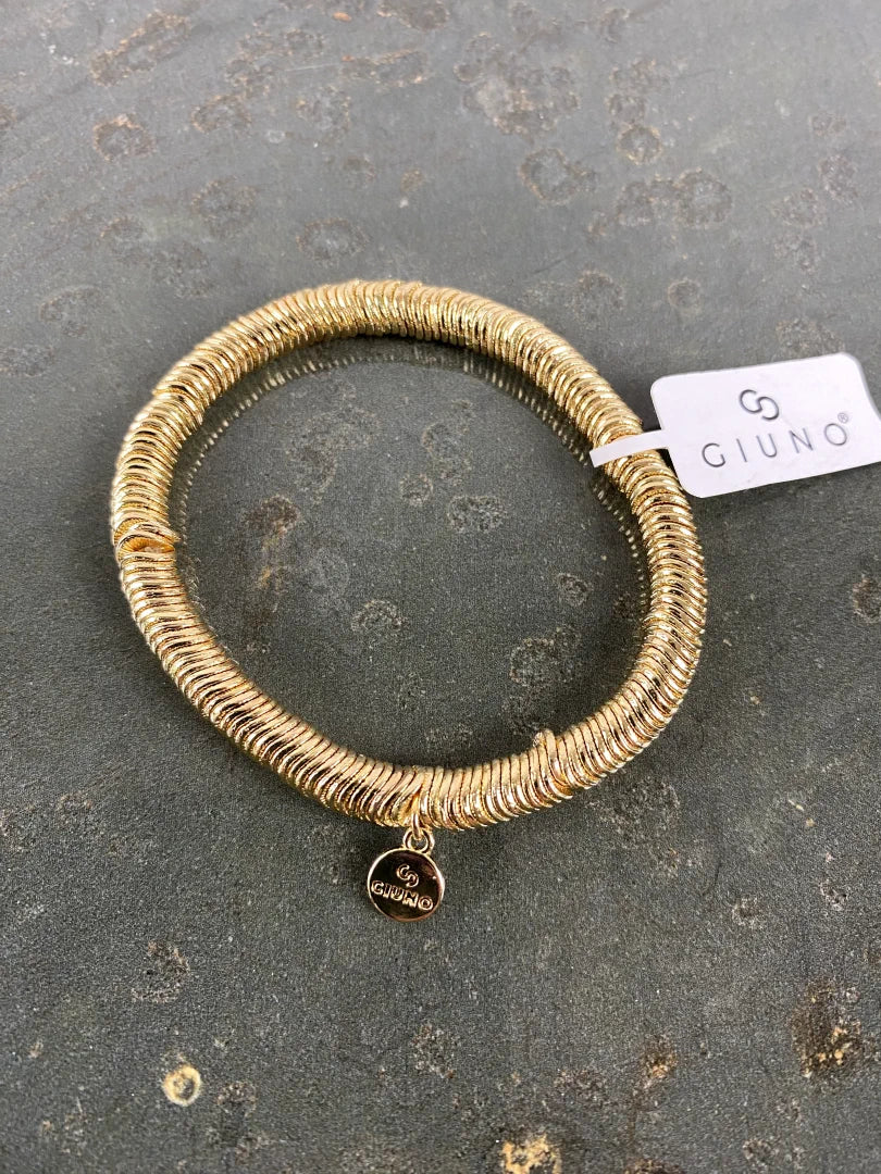 Elastische Armband aus aneinandergereihten goldenen verschiebbaren Metallscheiben mit dekorativer Quaste - perfekt für jeden Anlass, ein echter Hingucker!