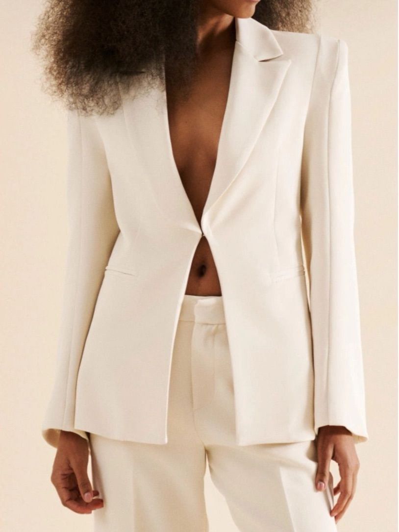 Eleganter Blazer mit markanten Schulterpolstern von Lumina in elegantem Créme. Perfekt für professionelle Anlässe oder stilvolle Alltagskombinationen.