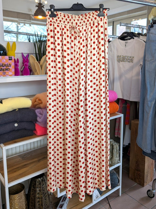 Elegante Hose aus weicher Satin-Viskose in Creme mit roten Polka Dots Pünktchen. Perfekt für stilbewusste Momente – ob casual oder zu besonderen Anlässen!