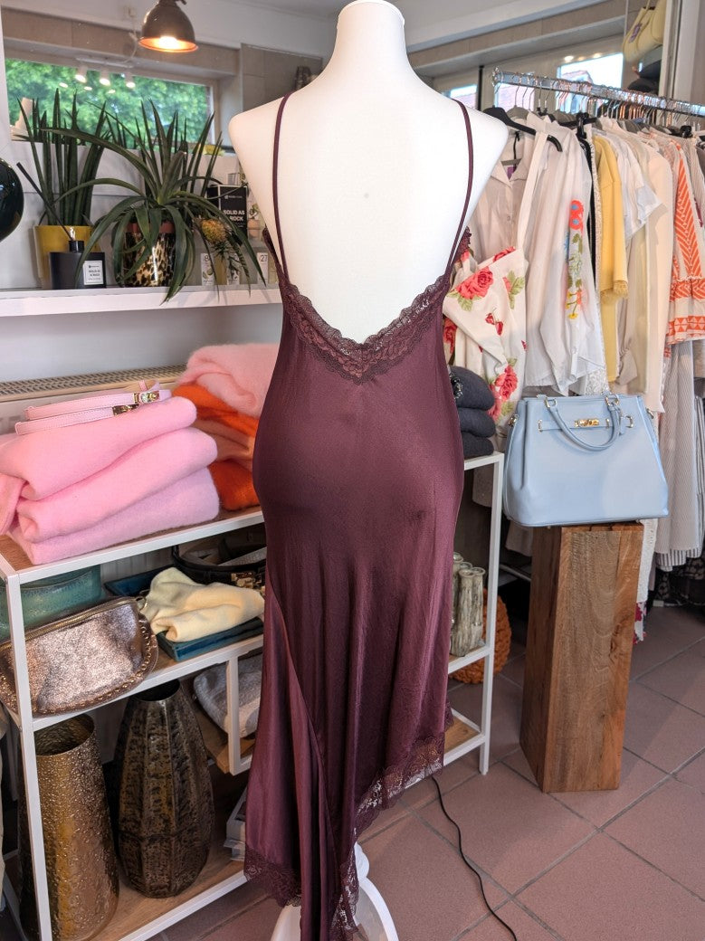 Das asymmetrische Kleid aus seidenmattem Viskose Satin in Bordeaux Rot mit roter Spitze wirkt ideal über Pants und Jeans - femininer absoluter Hingucker!
