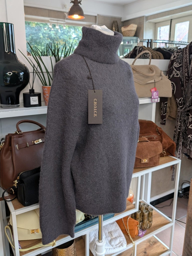 Der luxuriös samtweiche Anthrazit Rollkragenpullover verbindet zeitlose Eleganz mit unvergleichlichem Tragekomfort – perfekt für gemütliche Herbst-/ Wintertage!