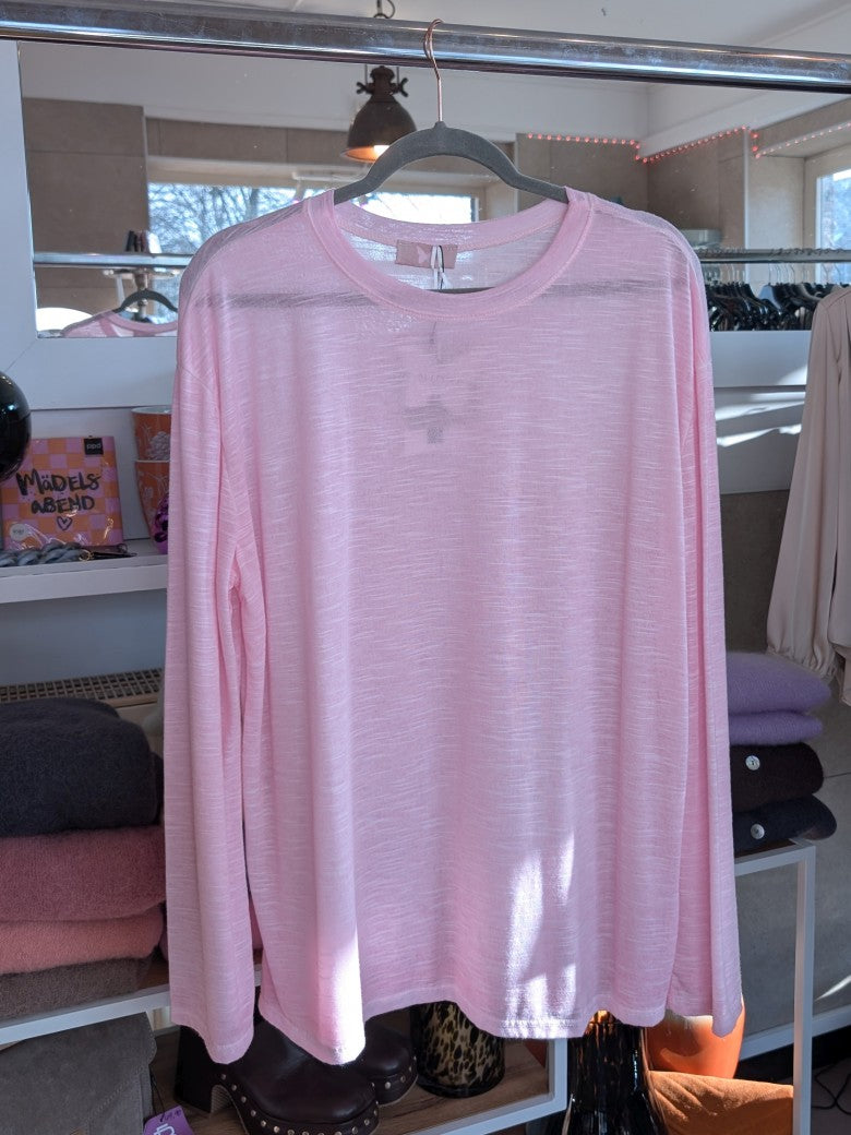 Verleihe Deinem Outfit mit diesem Shirt in Rosa einen Hauch von Transparenz. Das langärmlige und halbtransparente Design verleiht einen einzigartigen Look!