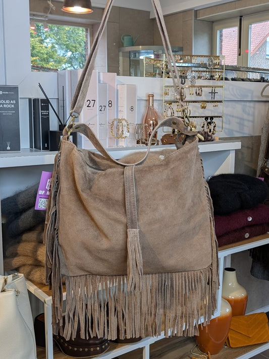 Die Wildledertasche in warmem Taupe überzeugt mit großzügigem Format, Schulterriemen, RV und stilvollen Fransen, die jedem Outfit eine trendige Note verleihen!